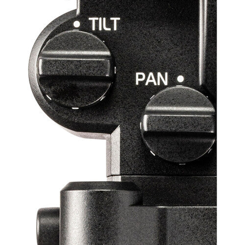 Close-up of a camera lens with 'TILT' and 'PAN' knobs on a white background
