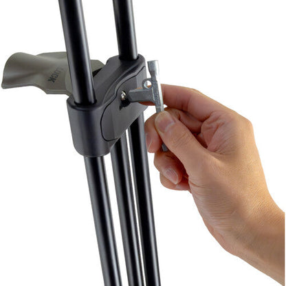 Hand adjusting a tripod leg with a white background